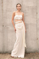 Beige Vaska crop top with short sleeves and fitted design, styled on a model against a neutral background.