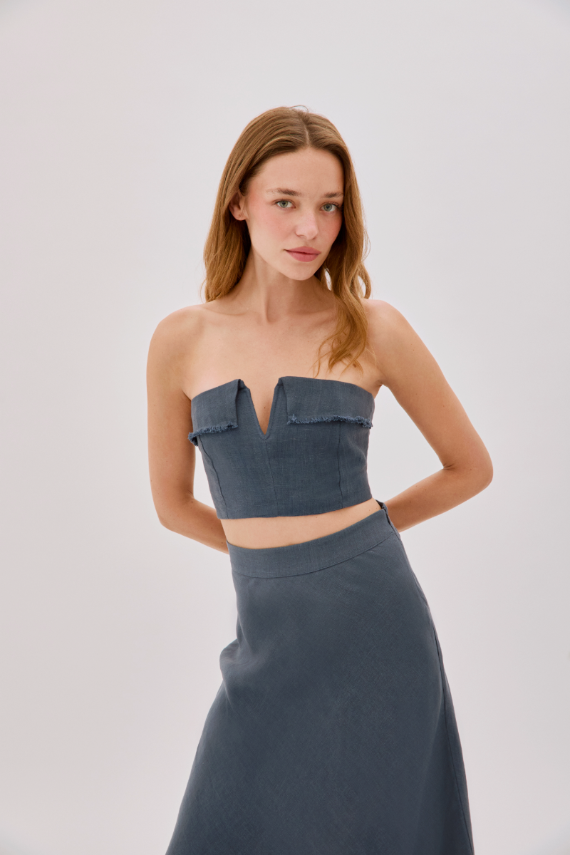 Labeca Clara Indigo Linen Maxi Skirt displayed on a model, showcasing its flowy fabric and elegant design.