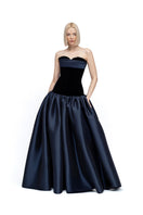 Black and navy Marina gown by Moon / Hakaan Yildirim, featuring elegant fabric and a flowing silhouette.