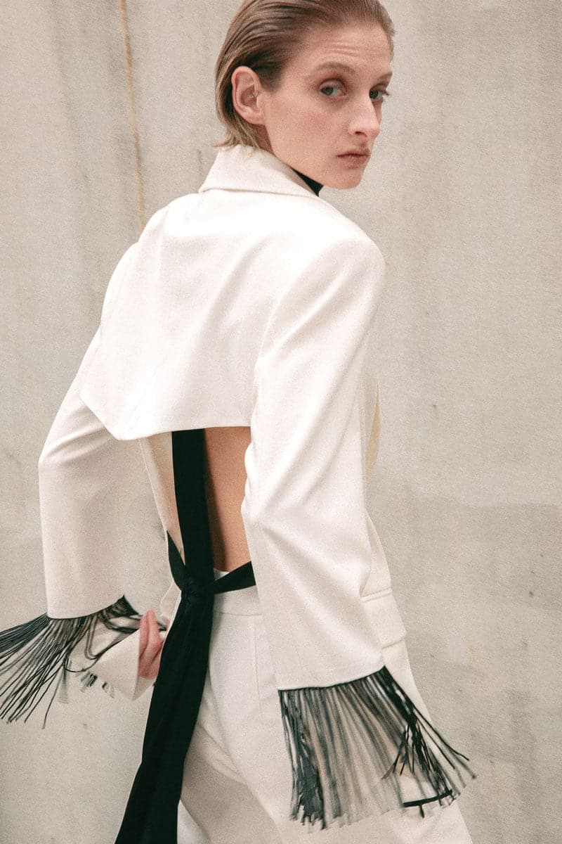 Vaska white blazer with beaded fringe detailing, stylish tailored jacket for a chic, trendy look.