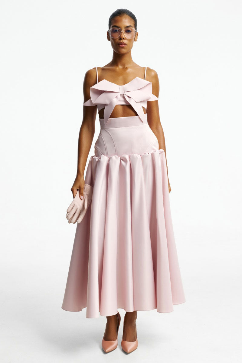 Blush-colored top with a bow detail from Santa Brands, featuring a stylish and feminine design perfect for casual or dressy occasions.