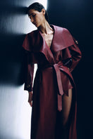 Kris Marán vegan leather maxi trench coat in burgundy with buckles, stylish long coat with a sleek silhouette.