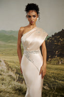 Champagne satin one-shoulder gown by HACCHIC COUTURE featuring elegant draping and a sleek, flowing silhouette.