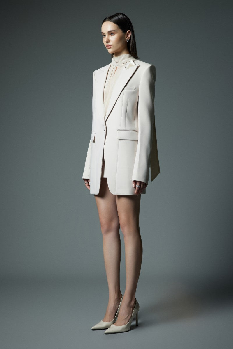 White LEKIEU Yorkshire mini skirt displayed on a model, showcasing its stylish fit and simple design.