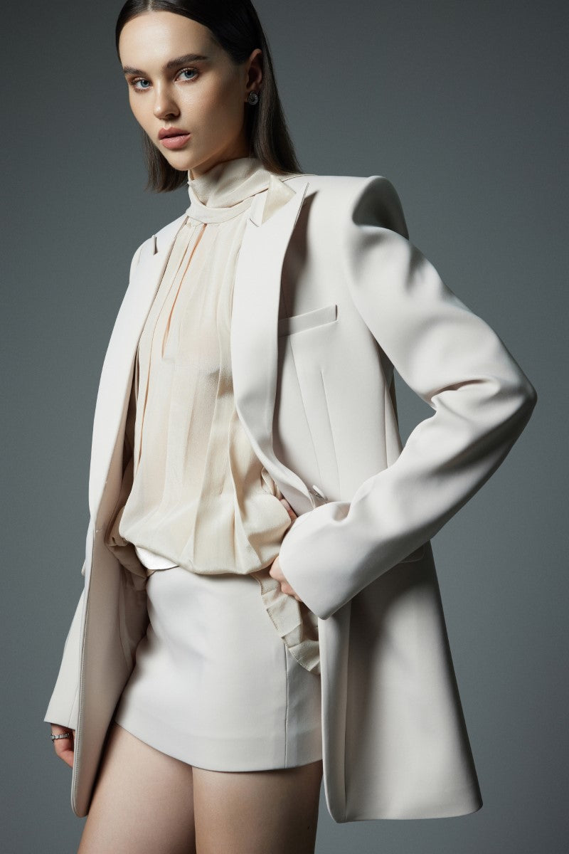 White Lekieu Dawlish shirt displayed on a hanger, showcasing a classic button-up design with a collared neckline.
