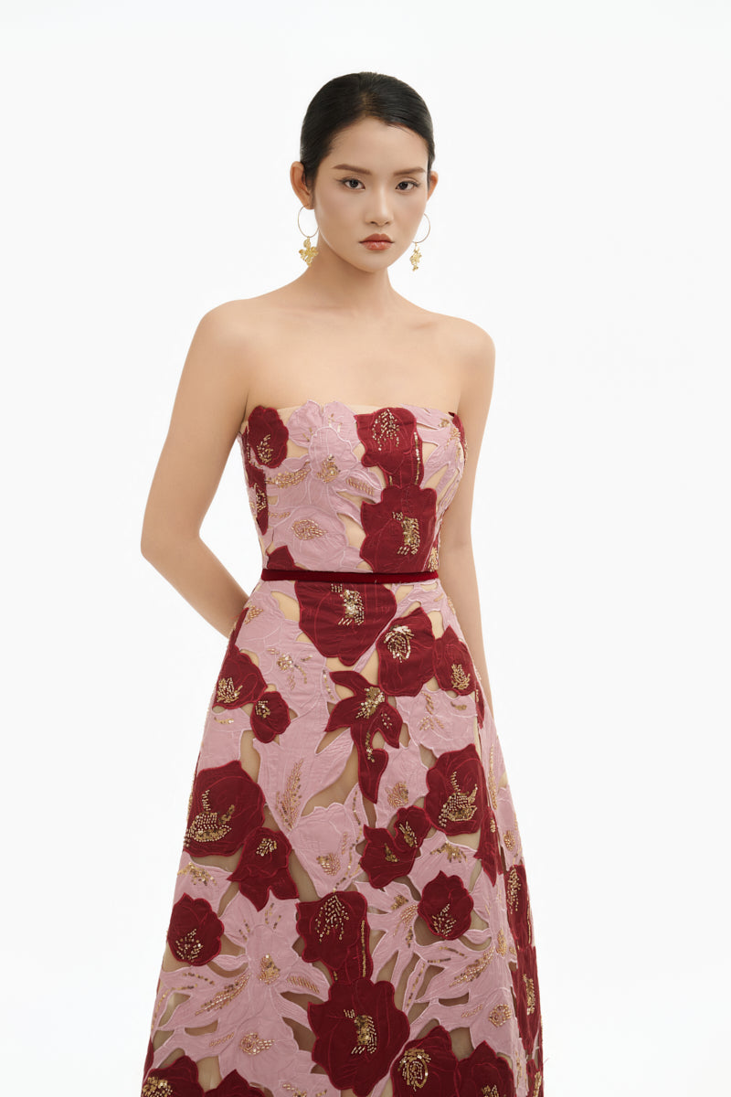 Elegant rose petal strapless gown by Happy Clothing, showcasing a flowing design with floral details and a fitted bodice.