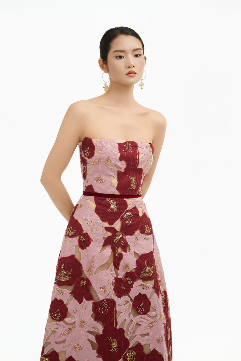 Elegant rose petal strapless gown by Happy Clothing, featuring flowing fabric and a fitted bodice, perfect for formal occasions.
