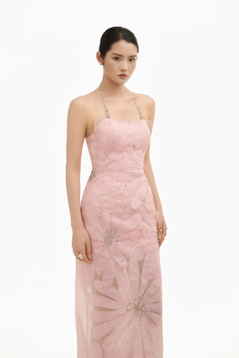 Soft pink floral gown by Happy Clothing featuring delicate crystal embellishments and flowing fabric, perfect for special occasions.