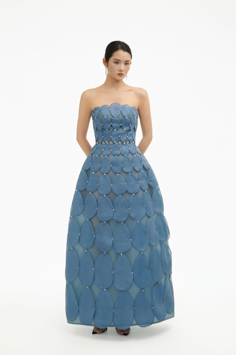 Blue 3D petal sculpture maxi gown by Happy Clothing featuring a flowing design and intricate petal details.