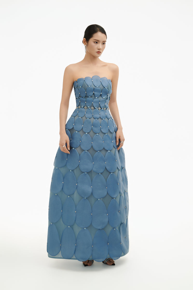 Blue 3D petal sculpture maxi gown by Happy Clothing featuring intricate petal details and flowing fabric.