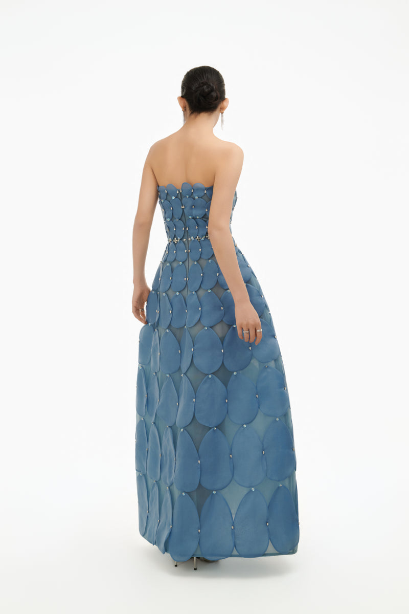 Blue 3D petal sculpted maxi gown from Happy Clothing, featuring intricate floral detailing and flowing fabric.