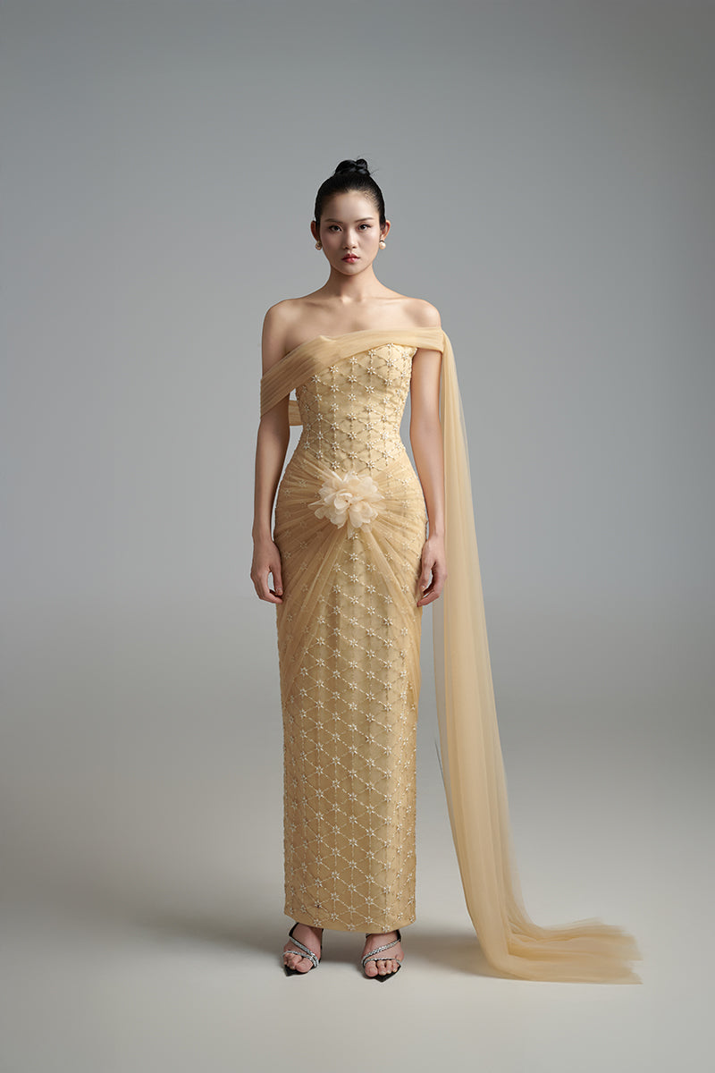 Light tan crystal gown by Happy Clothing featuring elegant embellishments and flowing fabric for formal occasions.