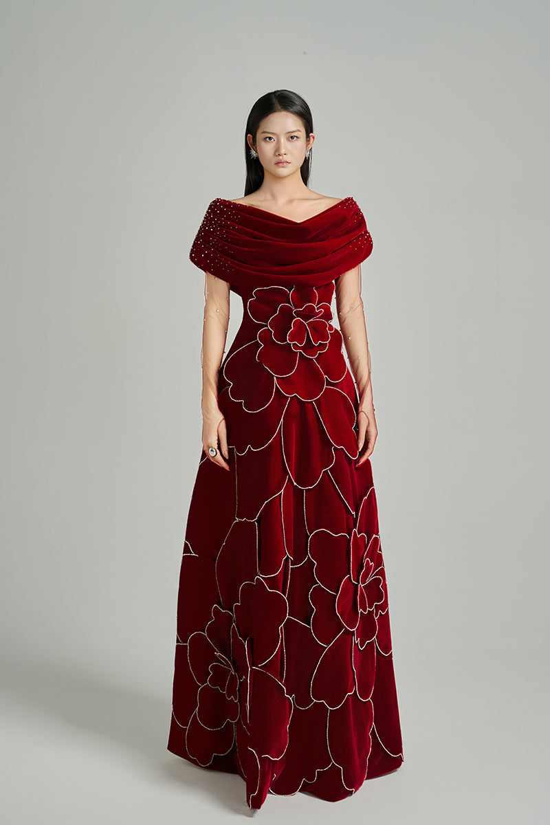 Red off-shoulder velvet gown by HAPPY CLOTHING featuring a stylish, elegant design perfect for formal occasions.