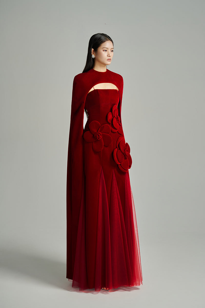 Red velvet Preston cape gown by Happy Clothing from the CULT MIA X Happy Clothing collection, featuring a luxurious petal design.