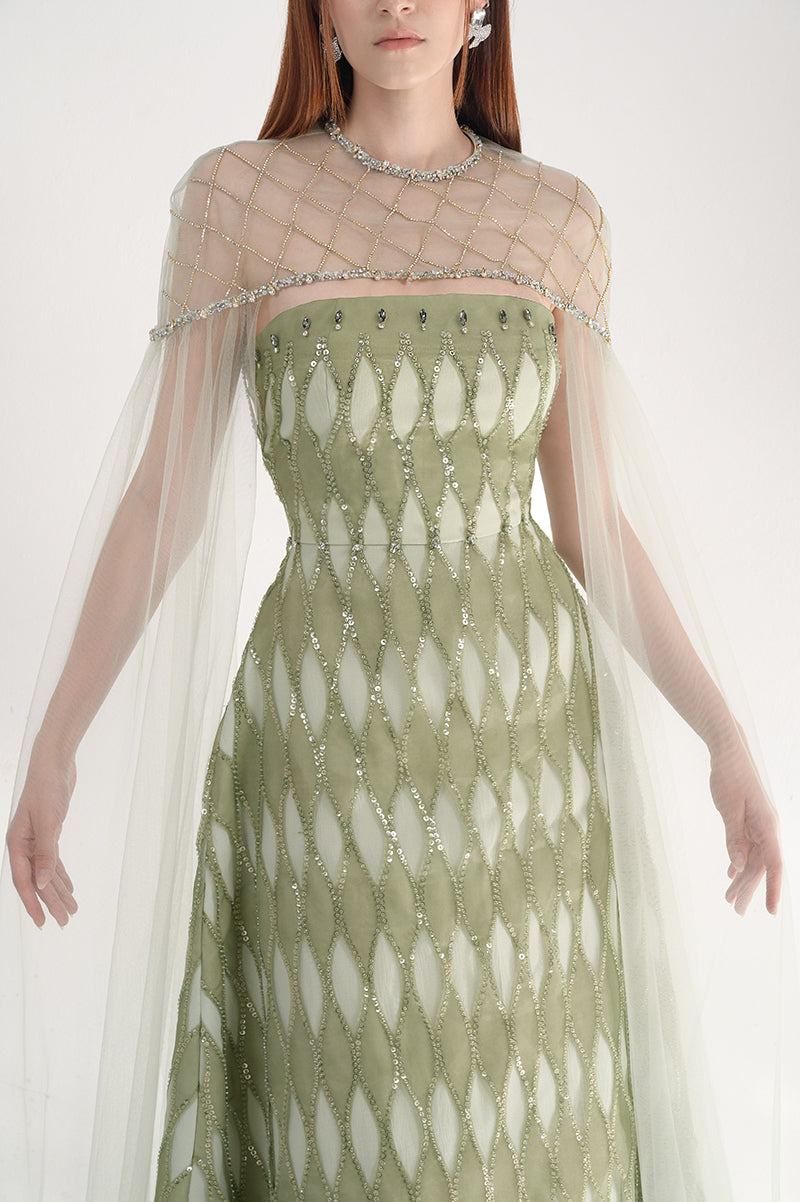 Elegant dusty mesh gown with embellishments and cape by Happy Clothing, showcasing intricate design and flowing fabric.