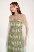 Embellished dusty mesh gown with cape by Happy Clothing, featuring intricate detailing and flowing design for elegant occasions.