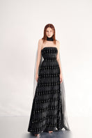 Black strapless gown with a floor-length design and elegant scarf detail from Happy Clothing, perfect for formal occasions.