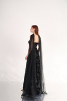 Black strapless floor-length gown with stone embellishments and scarf detail, designed by Happy Clothing.