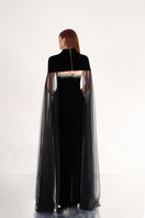Black velvet body gown with cape details from Happy Clothing, featuring elegant flowing fabric and sophisticated design.
