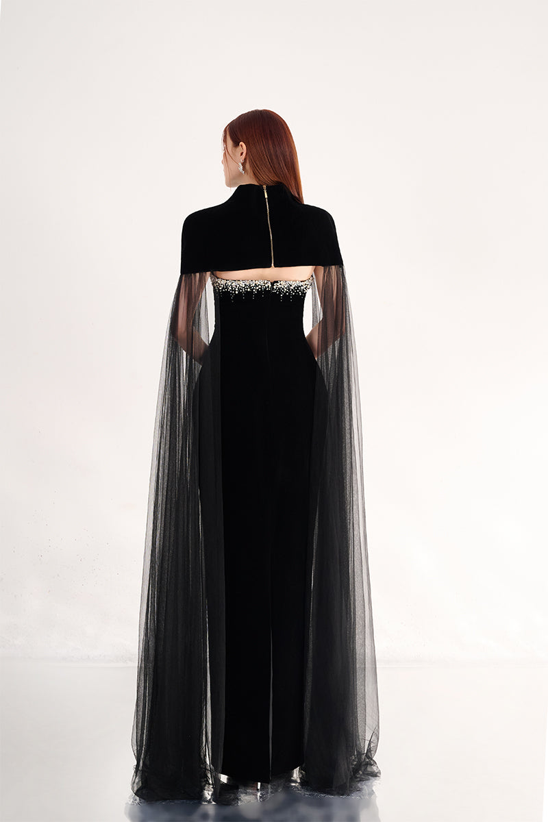 Black velvet body gown with cape details from Happy Clothing, featuring elegant flowing fabric and sophisticated design.