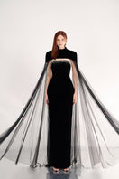 Black velvet gown with cape details from Happy Clothing, featuring a flowing silhouette and elegant design.