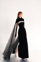 Black velvet gown with cape details by Happy Clothing, featuring elegant flowing fabric and intricate cape design.