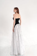 Black and white strapless gown by Happy Clothing, elegant formal dress with a fitted bodice and flowing skirt.