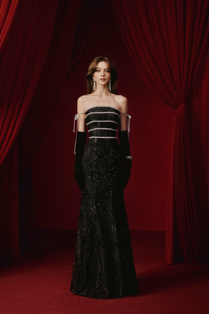 Elegant black gown by JOSÉPHINE, featuring a flowing silhouette and stylish design, perfect for formal occasions.