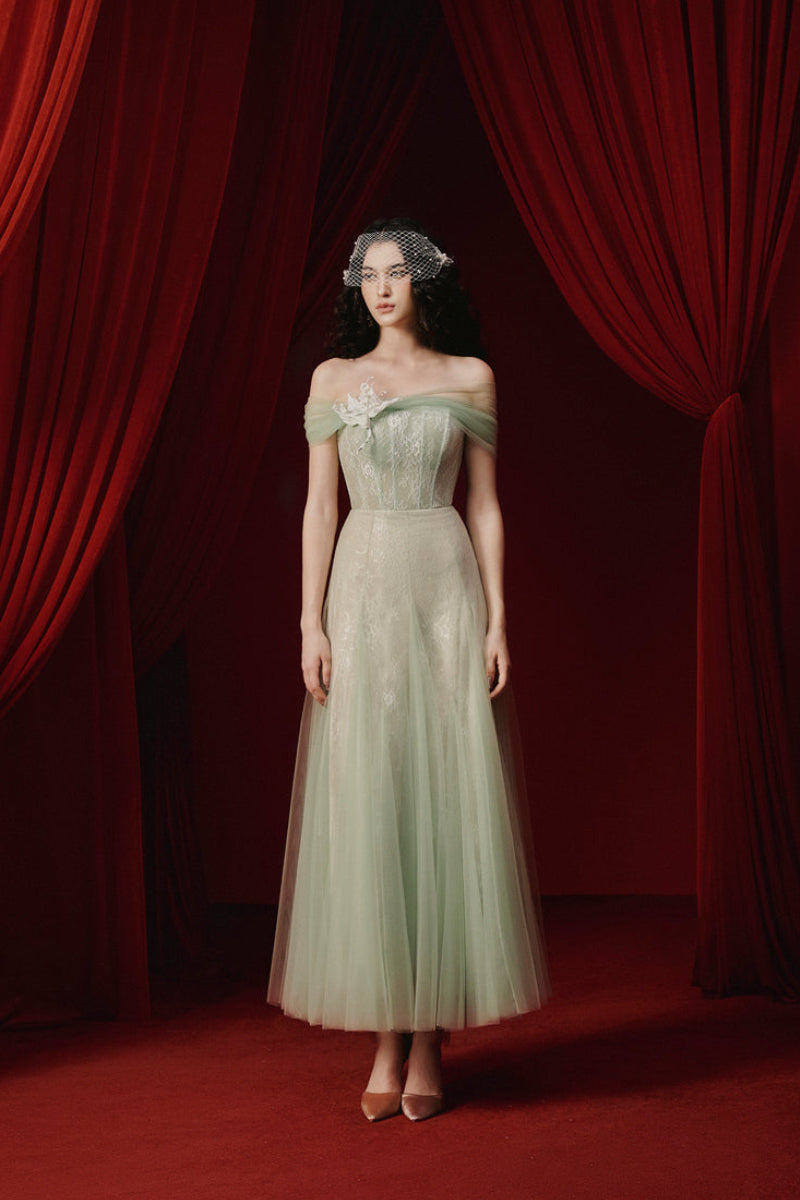 Elegant green TINLEY gown by JOSÉPHINE, flowing fabric with intricate detailing, perfect for formal occasions.