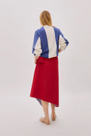 Labeca Keyra red and blue striped cotton midi skirt laid flat showing its vibrant pattern and breathable fabric.