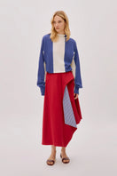 Labeca Keyra red and blue cotton striped midi skirt displayed on a hanger, showcasing its vibrant pattern and casual style.