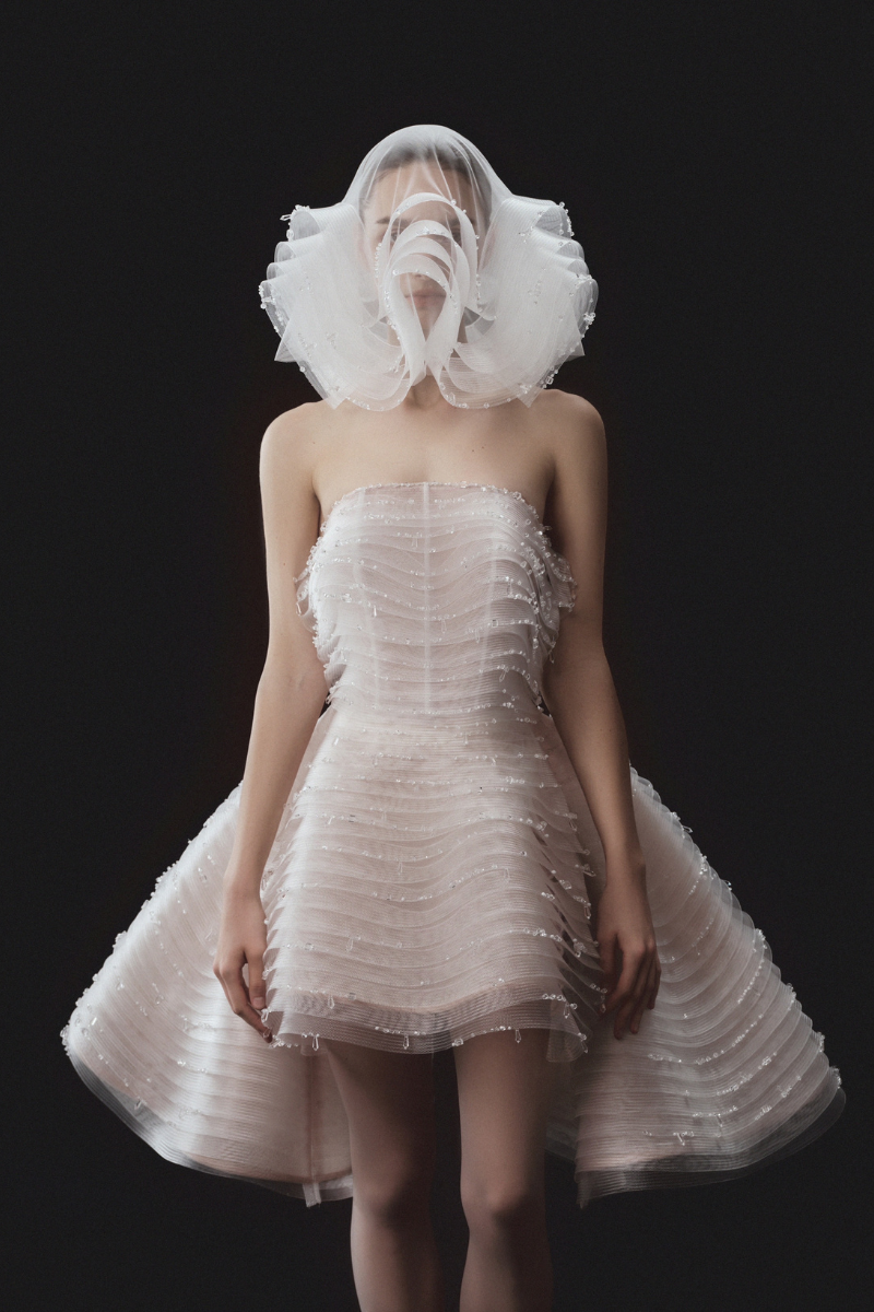 Beaded sleeveless layered bustier mini dress with matching overskirt by Phan Huy, featuring intricate beadwork and stylish design.
