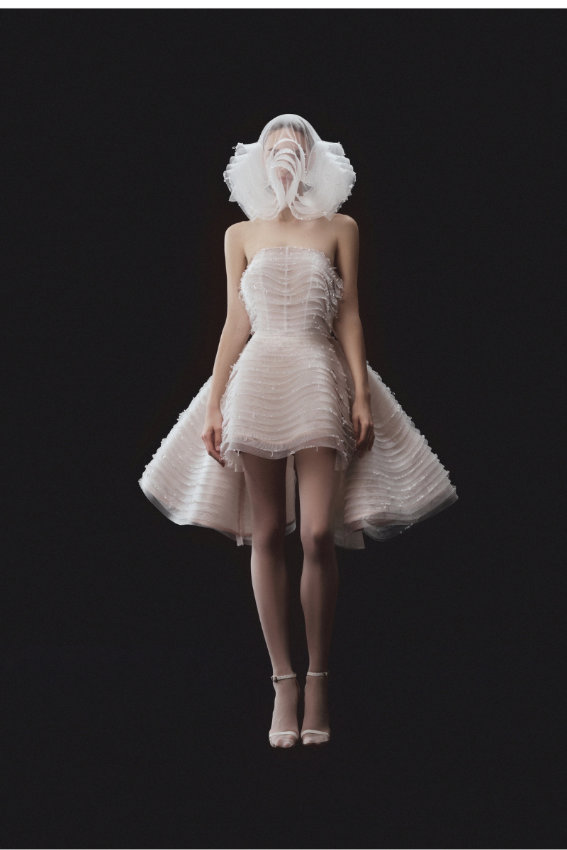 Beaded sleeveless layered bustier mini dress with matching overskirt by Phan Huy, featuring intricate beadwork and elegant design.