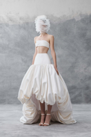 White draped bandeau top and balloon skirt co-ords by Phan Huy, featuring flowing fabric and stylish design.