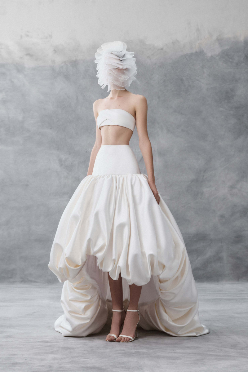 White draped bandeau top and balloon skirt co-ords by Phan Huy, featuring flowing fabric and stylish design.