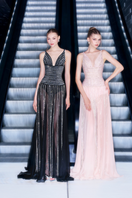 Black striped beaded gown by CEM featuring intricate beadwork and elegant design, showcased on a model.