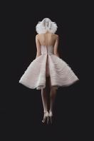 Beaded sleeveless layered bustier mini dress with matching overskirt by Phan Huy, featuring intricate beadwork and elegant design.