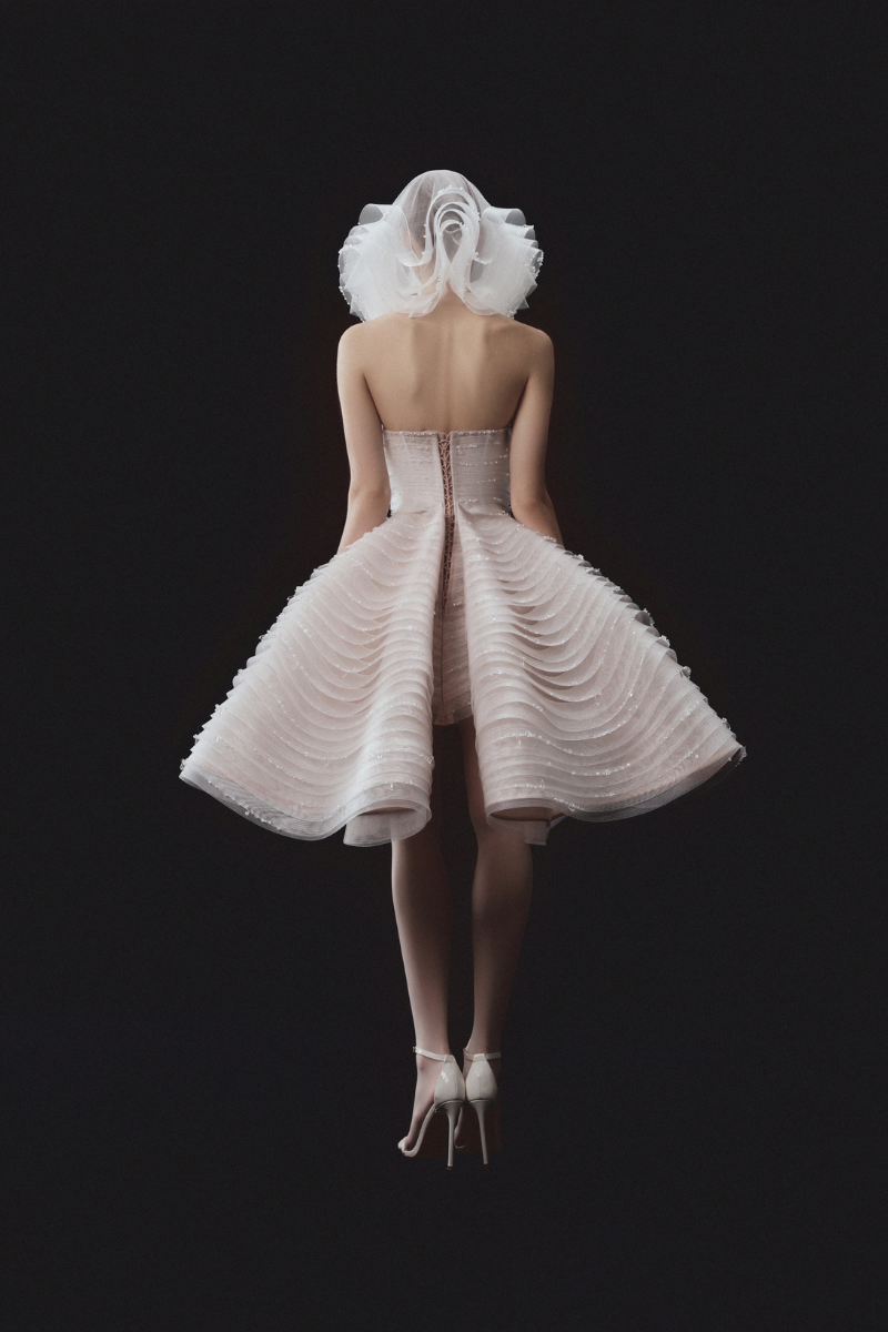 Beaded sleeveless layered bustier mini dress with matching overskirt by Phan Huy, featuring intricate beadwork and elegant design.