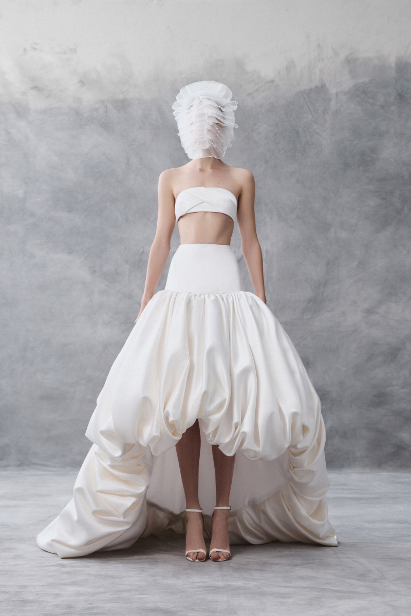White draped bandeau top and balloon skirt co-ords by Phan Huy, styled together in a fashionable outfit.