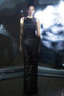 Black stripe beaded gown by CEM featuring intricate beadwork and a flowing silhouette, shown on a hanger against a neutral background.