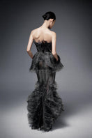 Dark gray pleated chiffon gown with crystal embroidery by Phan Huy, featuring flowing fabric and elegant design.