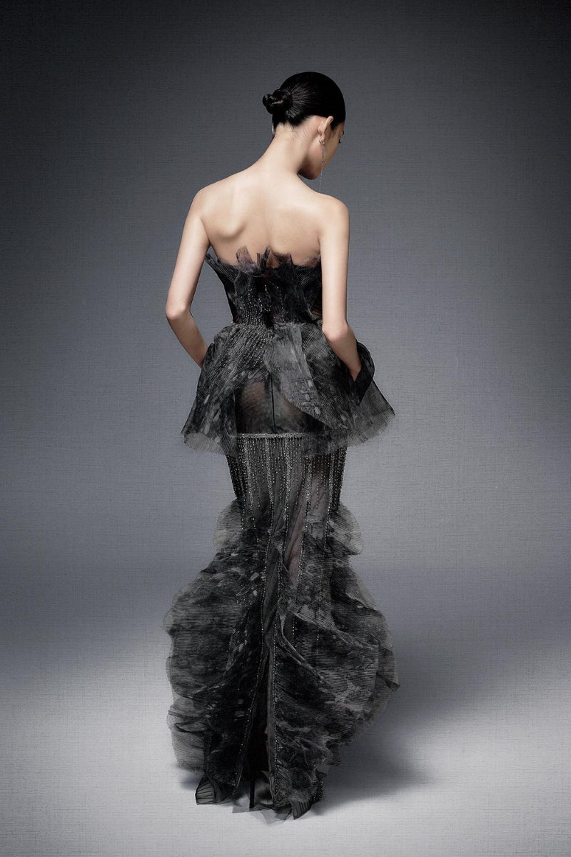Dark gray pleated chiffon gown with crystal embroidery by Phan Huy, featuring flowing fabric and elegant design.