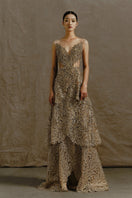 Deep gold V-neck corset gown by Phan Huy featuring metallic bead embroidery and playful fringe details.