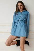 TT Studios Alexandra mini dress shown in a stylish, fitted design with a vibrant pattern and sleeveless silhouette.