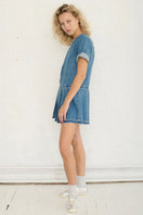 TT Studios Coco Dress mini dress featuring a stylish design, showcased on a model with a flowing silhouette and trendy details.