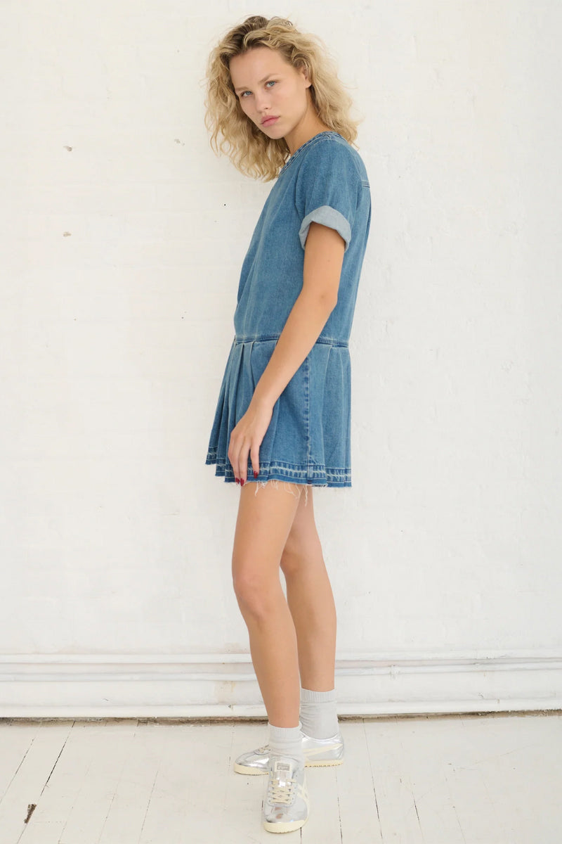 TT Studios Coco Dress mini dress featuring a stylish design, showcased on a model with a flowing silhouette and trendy details.