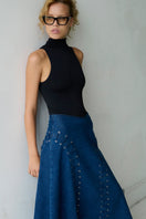 TT Studios JAN midi skirt featuring a stylish, flowy design with a high waist and elegant length, perfect for fashionable outfits.