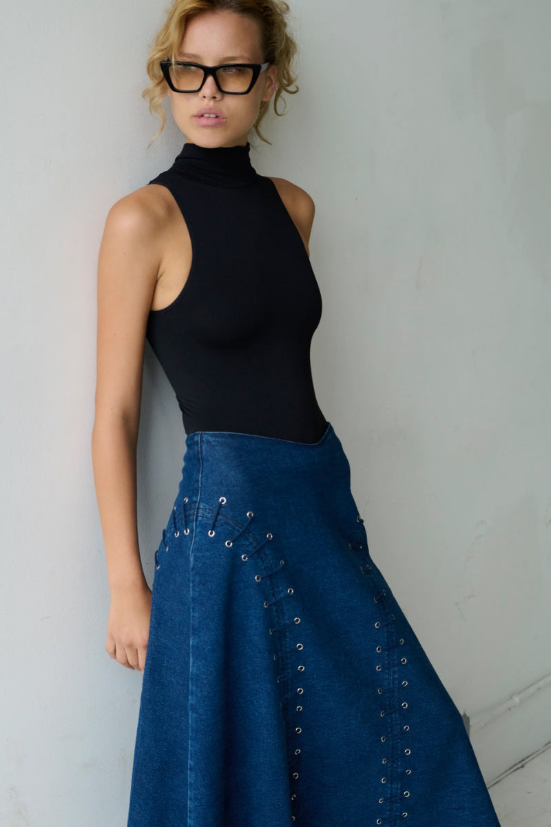 TT Studios JAN midi skirt featuring a stylish, flowy design with a high waist and elegant length, perfect for fashionable outfits.