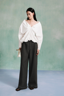 Light blue draped balloon blouse from LECIA, featuring soft fabric and relaxed fit, shown on a hanger.