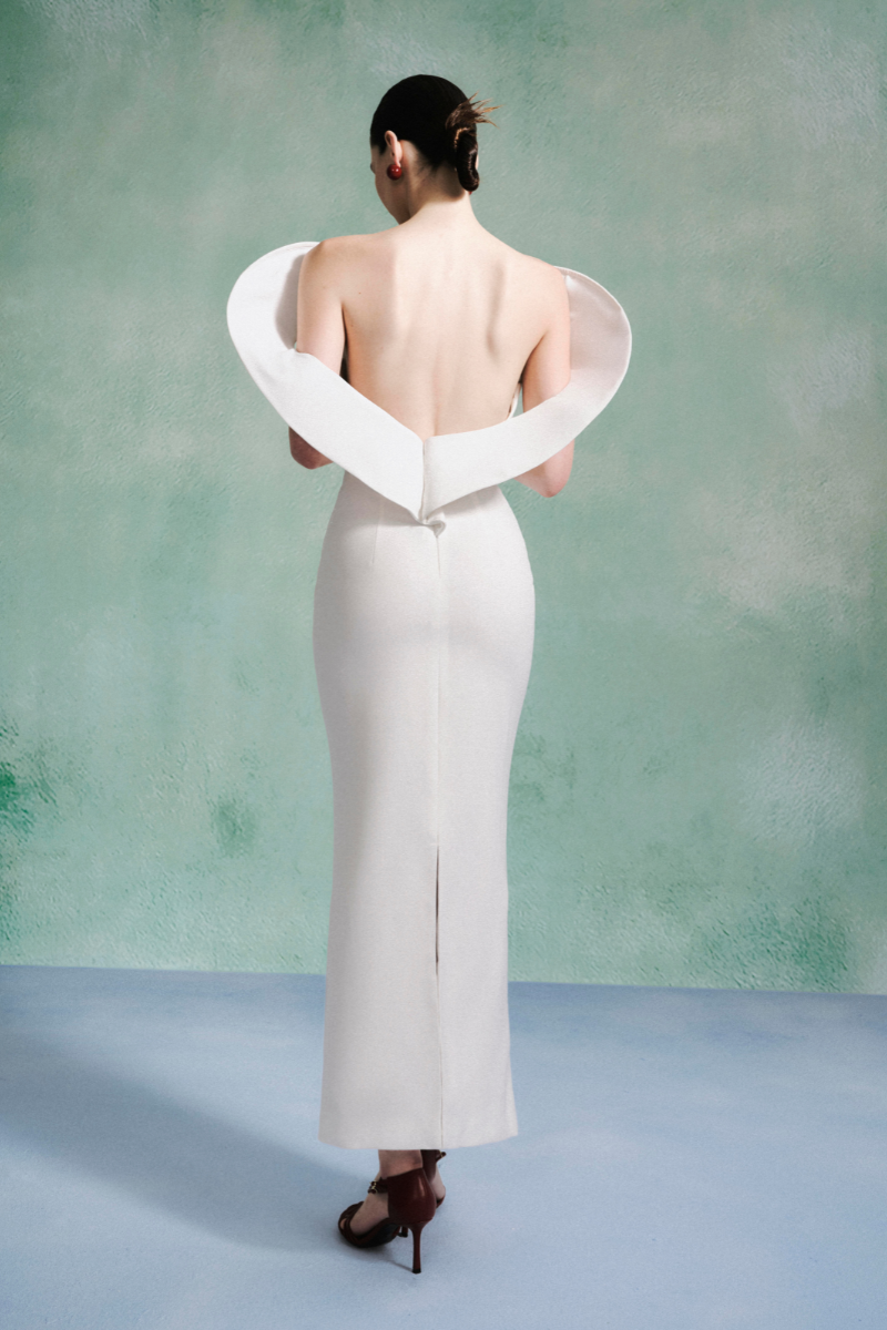Elegant petal-shoulder gown by LeCia featuring flowing fabric and a graceful silhouette, perfect for formal occasions.